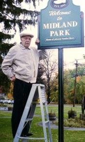 Johnny Vander Meer with sign on park that bears his name
